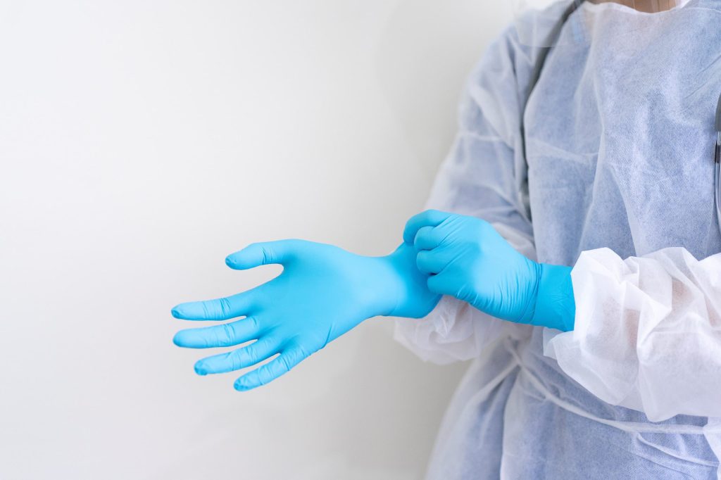 nurse donning PPE